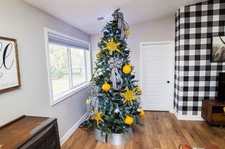 Marcus Larson / News-Register##
In one of the homes on the holiday tour, Rori Hartzell said she was going for a mid-century modern look when she
decorated this tree in mustard and black. The tree, one of six in the
house, stands in the family room upstairs.