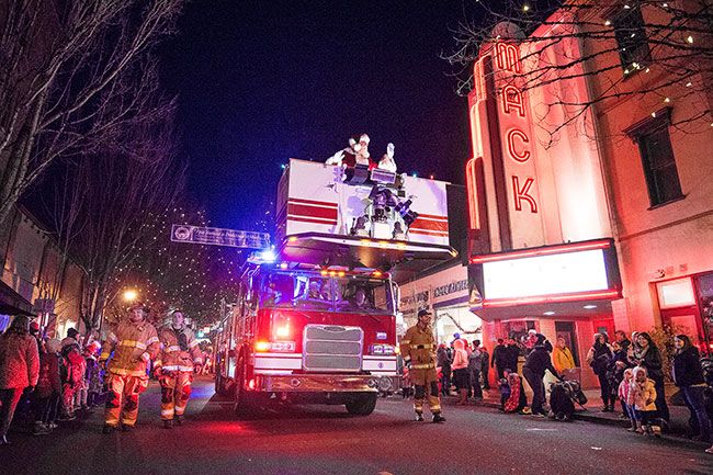 Marcus Larson / News-Register####A McMinnville fire truck carries Santa and Mrs. Claus during the annual holiday light parade.