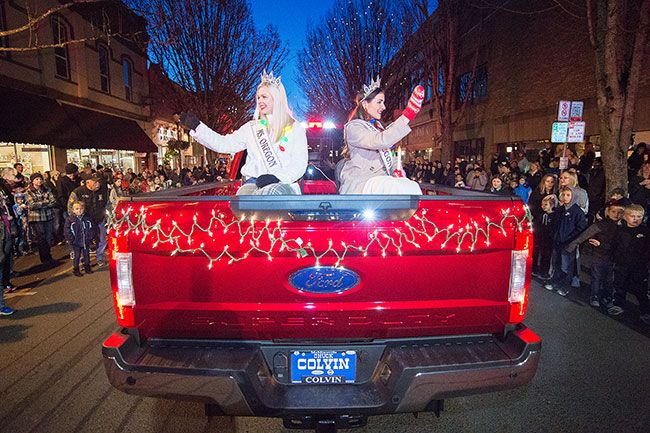 Marcus Larson/News-Register##
USOA Ms. Oregon Mallory Whitaker and USOA Mrs. Oregon Kara Campuzano wave at the crowd as they pass by during the annual McMinnville Christmas parade.