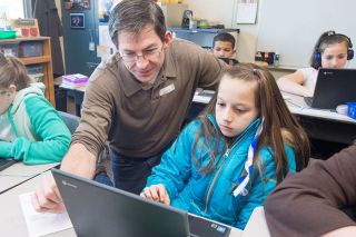 Marcus Larson/News-Register##
Chemeketa teacher Andrew Scholer helps fourth grader Isabella Nelson with her coding work during a special Hour of Code activity in Nikki Cedergreen s classroom at Memorial School. Marcus Larson/News-Register##
Chemeketa teacher Andrew Scholer helps fourth grader Isabella Nelson with her coding work during a special Hour of Code activity in Nikki Cedergreen s classroom at Memorial School.