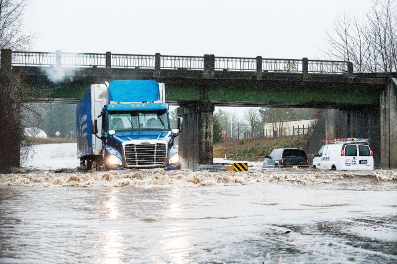 Marcus Larson/News-Register##Several drivers brave passage on Highway 99W at the St. Joseph overpass Monday morning as water levels rise quickly.  Highway 99W was closed most of Monday, but is open Tuesday morning.