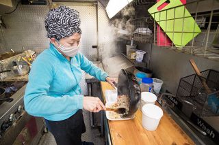 Marcus Larson/News-Register ##
Kate Miller, a native of Bangkok, Thailand, prepares a freshly cooked meal of pineapple chicken fried rice in her food truck, Kate’s Thai Cuisine.