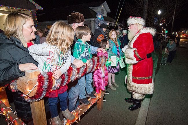 Marcus Larson/News-Register##
After arriving at the Amity Community Center, Santa visits with excited
children Friday night.