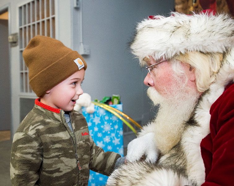 Marcus Larson/News-Register##
Four-year-old Briggden Reed, at left, asks Santa for a T-Rex dinosaur
toy for Christmas during the Amity Christmas event on Friday. Amity
residents came out in droves to watch the tree lighting outside the
community center and visit Santa inside.