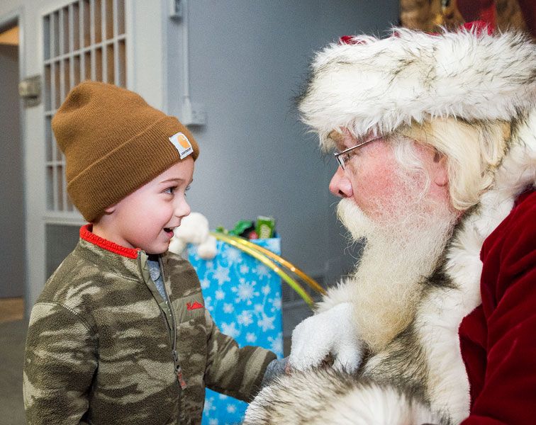 Marcus Larson/News-Register##
Four-year-old Briggden Reed, at left, asks Santa for a T-Rex dinosaur
toy for Christmas during the Amity Christmas event on Friday. Amity
residents came out in droves to watch the tree lighting outside the
community center and visit Santa inside.