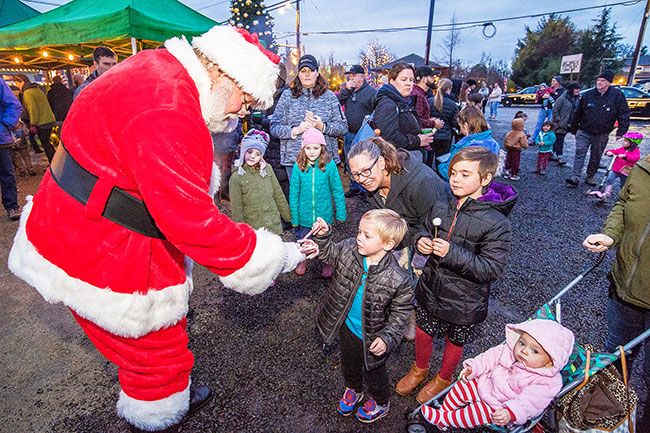 Marcus Larson/News-Register##
Thorin Keinonen receives a candy cane from Santa during Carlton s
Christmas festivities Saturday.