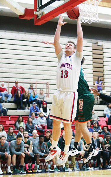 Rockne Roll/News-Register##
Linfield s Tyler Watts take the ball strong to the hoop in the game against LaVerne. The  Cats rally fell short as they lost 87-80.