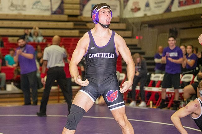 Rusty Rae/News-Register##Price Pothier pumps up the crowd after pinning his opponent.