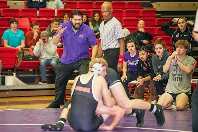 Rusty Rae/News-Register##Chad Hanke shouts instructions to his wrestler during Sunday’s meet against Southern Oregon. Hanke had a successful college career at Oregon State before turning to coaching.