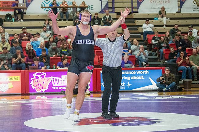 Rusty Rae/News-Register##McMinnville native Jacob Barnes raises his arms in victory after defeating his opponent on Sunday.