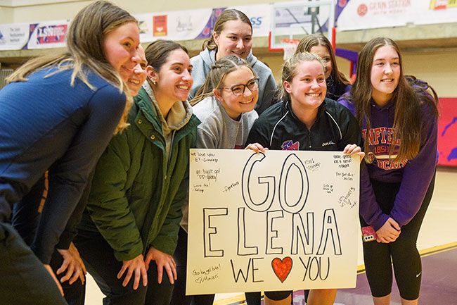 Rusty Rae/News-Register##Elena Kroll smiles with a group of friends who came to support her after Sunday’s meet.