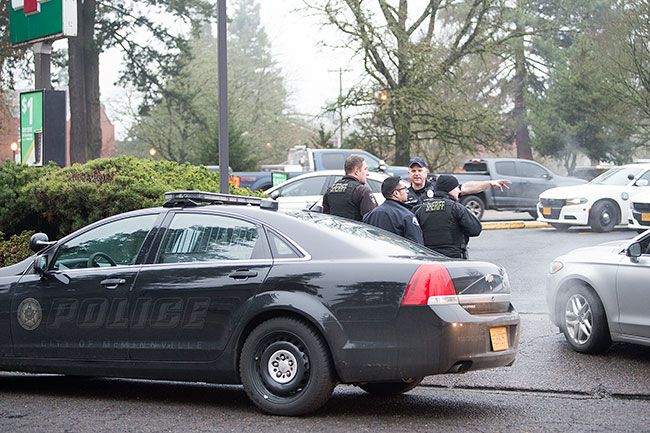 Marcus Larson/News-Register##
After apprehending the suspect near 7-Eleven, McMinnville police officers and Yamhill County Sheriff deputies discuss searching the area and controlling the scene.