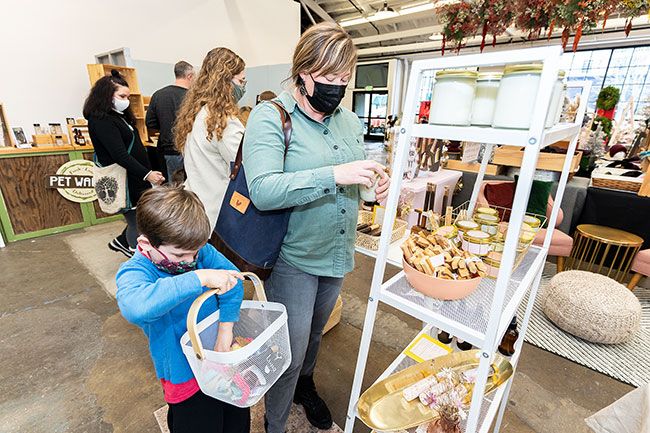 Marcus Larson/News-Register##Sinell Harney and her son Juneau shop for gifts at the McMinnville Holiday Market in December. Oregon’s indoor mask mandate ends at midnight tonight.