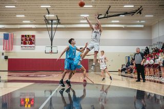 Rusty Rae/News-Register##Boston Hodges rises up for a mid-range jump shot over an Oregon Episcopal defender. Hodges scored 20 of his game-high 23 points in the second half to help lift Dayton to victory.
