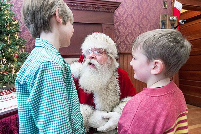 Marcus Larson/News-Register##
Ayden Larkin and his younger brother, Asher, meet with Santa at Serendipity Ice Cream.