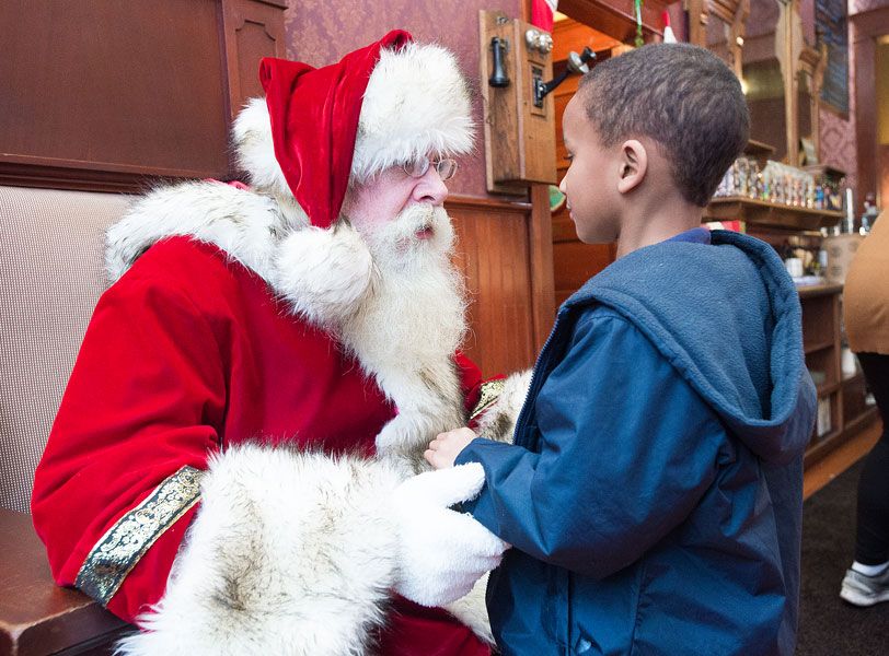 Marcus Larson/News-Register##
Santa talks with Justice Robinson, who is meeting Mr. Claus for the first time. According to Santa s assistant Darrell Flood, the Christmas figure loves talking with children and seeing their eyes light up.