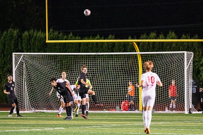 Rusty Rae/News-Register##Spencer Stritzke helps thwart an offensive chance in Mac’s September match against Lincoln. He hopes to continue playing soccer in college.