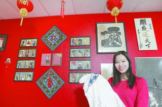Rockne Roll/News-Register##
Linfield College visiting scholar Lily Lin shows off a traditional Chinese dress in her classroom on campus. Lin teaches language and Chinese culture classes.