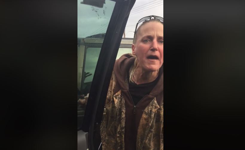 Screenshot of a video posted to Facebook by Emora Roberson of a woman wielding a knife while unleashing a racist rant against Roberson and others in the car.