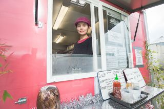 Marcus Larson/News-RegisterPhaijit Phrommala Nofsinger, known as Mayla, pauses between cooking tasks in her Thail food cart in Carlton. She loves to prepare authentic dishes from her homeland, where New Year’s and the Water Festival are the largest celebrations of the year.