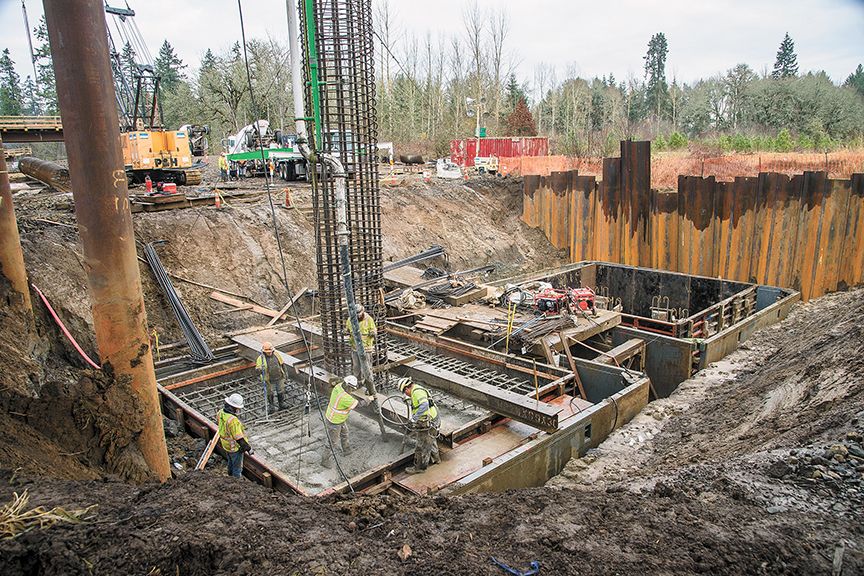 Rusty Rae/News-Register##Wildish Construction crew pours concrete for massive footing at the mid-section of what will be the new South Yamhill River bridge. Concrete pouring is scheduled to resume after Jan. 1 and continue for several weeks.
