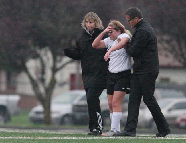 Rockne Roll/News-Register##
Melina Alvarez (in white) is helped from the field after sustaining an injury in Wednesday s playoff match against Cascade Christian. Alvarez was not allowed to return as Dayton sustained a season-ending 1-0 defeat.