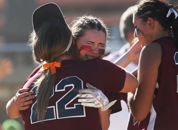 Rockne Roll/News-Register##Dayton sophomore Gabby Shadden (center) embraces senior Rachael Fluke (22) following the Pirates  5-4 loss to Rainier in the OSAA Class 3A softball state championship game Friday at the Oregon State University softball complex in Corvallis.