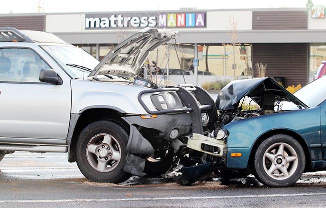 Rockne Roll/News-Register##
A compact sedan and an SUV collided head on at the intersection of Northwest Evans Street and Highway 99W in McMinnville on Wednesday, Nov. 23.