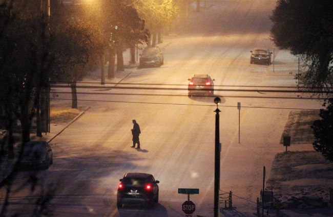 Rockne Roll/News-Register##Pedestrians and cars contend with a blanket of snow on Northwest Evans Street near downtown McMinnville just after sunset Wednesday, Dec. 14. A winter storm warning remains in effect for the area through midnight Wednesday.