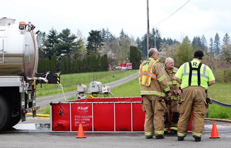 Rockne Roll/News-Register##
Firefighters monitor a portable reservoir used to fight a house fire along Lafayette Highway north of Hopewell Wednesday afternoon.