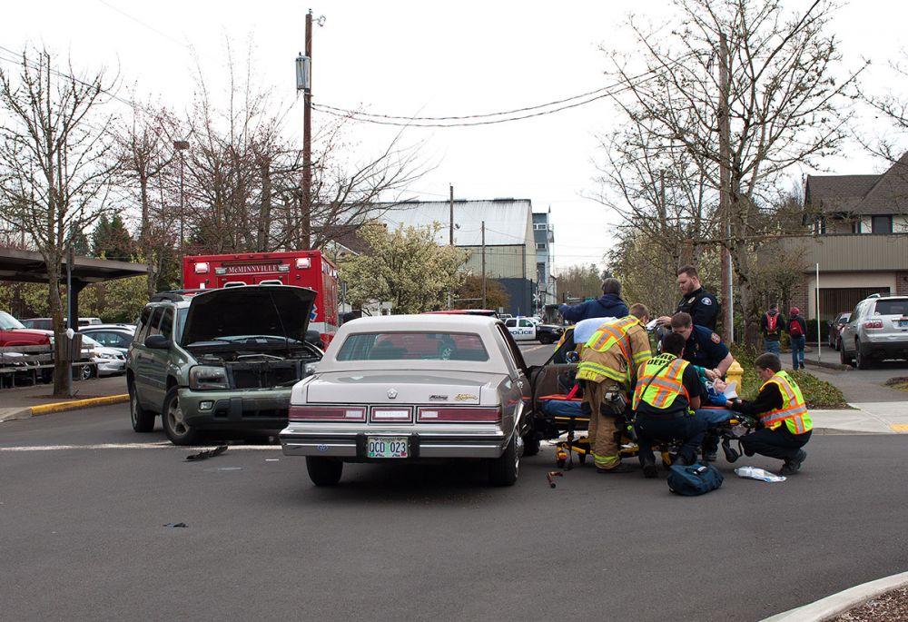Rockne Roll/News-Register##
McMinnville Fire Department medics extract an injured patient from a vehicle at the scene of a head-on crash Tuesday morning on Northeast Fifth Street in front of the Yamhill County Courthouse.
