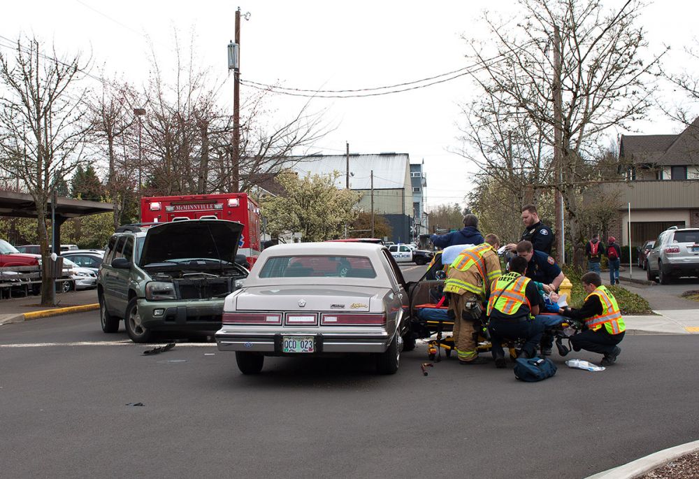 Rockne Roll/News-Register##
McMinnville Fire Department medics extract an injured patient from a vehicle at the scene of a head-on crash Tuesday morning on Northeast Fifth Street in front of the Yamhill County Courthouse.