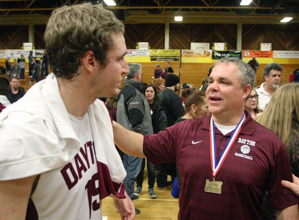 Rockne Roll/News-Register##
Dayton senior Zach Spink and Pirates  girls head coach Scott Spink confer following the Pirate boys  third-place game victory over Portland Adventist on Saturday, March 5 at North Bend High School.