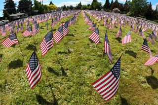 Marcus Larson/News-Register##Nearly 6,000 American flags fly on a field near McMinnville Christian Academy on Baker Creek Road. Students posted the Memorial Day display to honor Oregonians who ve died in military service.