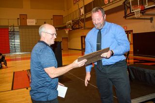 Rusty Rae/News-Register##MHS Athletic Director Ryan McIrvin presents swim coach Jason Hafner with his Hall of Fame plaque, set to be display among the other members outside of the main gymnasium. Rusty Rae/News-Register##MHS Athletic Director Ryan McIrvin presents swim coach Jason Hafner with his Hall of Fame plaque, set to be display among the other members outside of the main gymnasium.