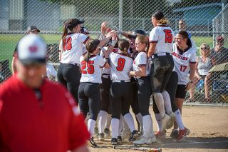 Rusty Rae/News-Register##The Grizzlies congratulate Kaylee Dinger, who drilled a three-run home run during a five-run first inning in McMinnville’s 7-0 win over Sherwood on Tuesday. For the second straight year, Mac is looking to break its own school record for most runs in a season.
