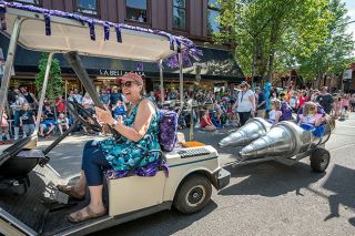 Rachel Thompson/News-Register##Carlton Observatory’s Janet Zuelke tows Ruby Lineberger and Nora Turner in a rocketship float with a “Search for Extra Terrestrials” theme in Saturday’s UFO parade. Zuelke posted on Facebook, “Our search was a huge success; we found hundreds.”