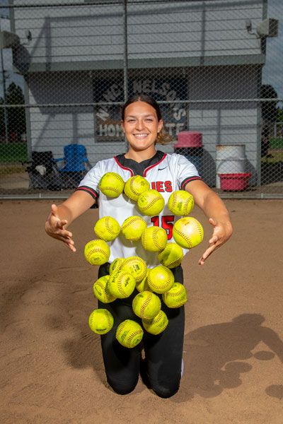 Rusty Rae/News-Register##Abby Carsley with 20 softballs, one representing each of her 20 home runs in her record breaking season. While she will work out with previous record holder Brynn McManus this summer, she said she won’t talk smack about the record, noting she has a lot of respect for her and her game.