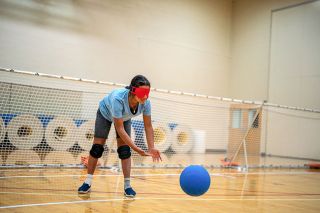 Photo Courtesy of the NWABA##An athlete prepares to catch a goalball, a ball that has metal rings in the interior that allow it to be heard. Goalball was specifically developed for individuals with visual impairments, and it has become the most popular sport for those individuals in the world.