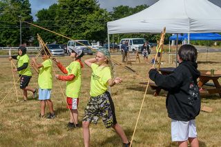 Rusty Rae/News-Register##Archaeology campers Armando Contreras, Logan Kneeland, Tiberius Bailey and Satara Blanchard, left to right, sharpen their spear throwing skills with the aid of an atlatl. Aaron King, far right, prepares his spear.