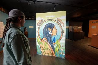 Rusty Rae/News-Register##Chachalu employee Joseph Ham views the work by Grand Ronde artist Steph Littlebird at the centerpiece of the Shimkhin exhibit. In their artist statement, Littlebird wrote, “Being a Two Spirit artist means I have a spiritual responsibility to create art that uplifts Native people and centers our cultural values. This is why I do what I do, to make sure Indigenous people know they are seen and loved.”