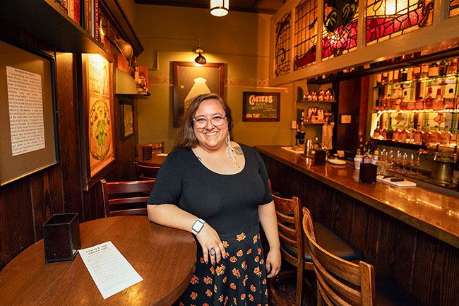Rachel Thompson/News-Register##Hotel Oregon manager Em Thomas, in the Carter the Great cellar bar, said she enjoys working for the family-owned McMenamins chain, which is marking 40 years this summer. Like other McMenamins properties, she said, the McMinnville hotel is community oriented, helping with local fundraisers and hosting events such as the UFO Festival.
