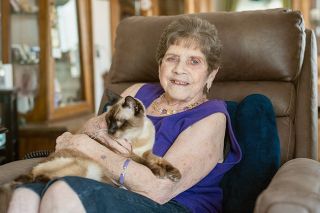 Rachel Thompson/ News-Register##Bobbi Dabling cuddles Tucker, her beloved cat. She spends time with Tucker when she’s not swimming or doing other activities with her daughters and friends.