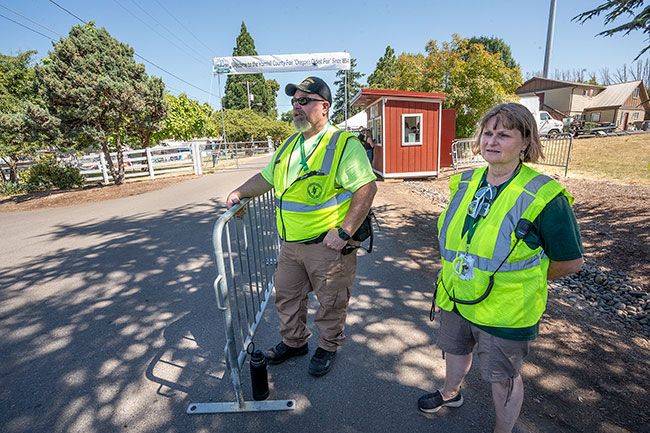 Rachel Thompson/News-Register##CERT volunteers Dan Swart, left, Gaston, and Sandra Utt, Dayton, serve at the organization’s information and official greeters’ station at Yamhill County Fair.