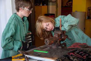 Rusty Rae/News-Register file photo##In this picture from 2023, Archer Carroll, right, flattens and bends a piece of copper pipe to make a bracelet in summer school. With him is Carter Lewis; both were sixth graders at Patton Middle School participating in the McMinnville summer school program.