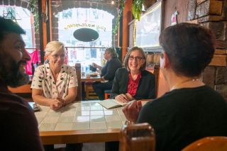 Rusty Rae/News-Register##Los Molcajetes co-owner, Munira Santana, right, speaks with Rep. Andrea Salinas, across the table at right, and Mayor Remy Drabkin, during the Aug. 22 downtown visit. At left is Dave Perez, a Veterans Affairs caseworker who served as translator on the tour.