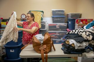 Rusty Rae/News-Register##Volunteer Evelyn Tushar sorts items donated to the Dayton Clothes Closet, a giveaway program with quarters in the Dayton First Baptist Church. People in Dayton and the surrounding area can shop once a month from 10 a.m. to 1 p.m. Mondays and Wednesdays.