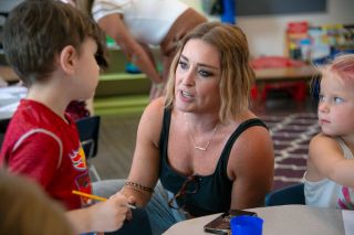 Rusty Rae/News-Register##New Dayton Superintendent Amy Fast talks with Dakotah Norwest during Kindergarten Camp in August. Fellow kindergartner Reagan Riddle is at right. Children were getting to know their new school as Fast was getting acquainted with the district.