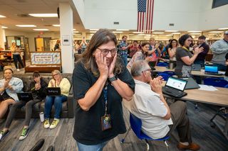 Rachel Thompson/News-Register##Science teacher Michele Reschly reacts with both happiness and humility as she is named a regional teacher of the year during Wednesday’s staff meeting at Patton Middle School. Reschly said she loves teaching science, technology, engineering and math classes to adolescents.