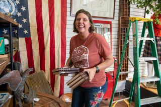 Rusty Rae/News-Register##Katie Wennerstrom sets out vintage books and other items in the shop she’s opening with her friend Joan Steiner, Vintage on Third. The grand opening is scheduled for Friday, Sept. 29.